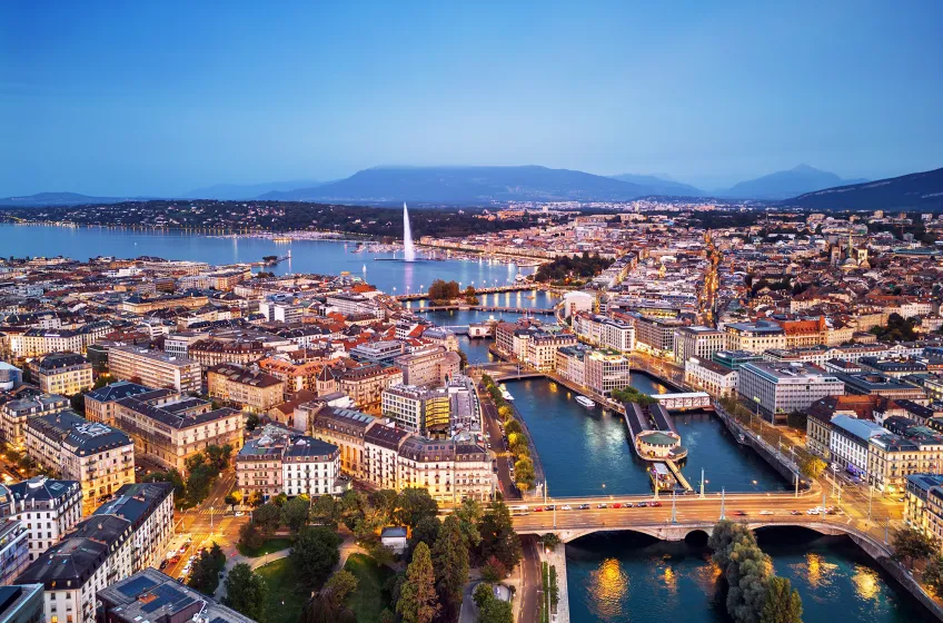 Aerial view of Geneva at dusk with the Jet d&rsquo;Eau and Lake Geneva